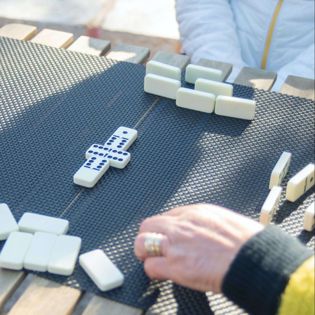 A Group of People Playing Dominoes