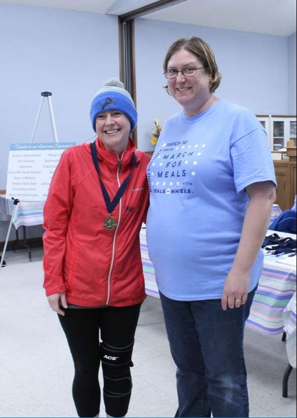 Laura Miller, Female 5K Overall winner, stands next to Jill Ohnesorge.